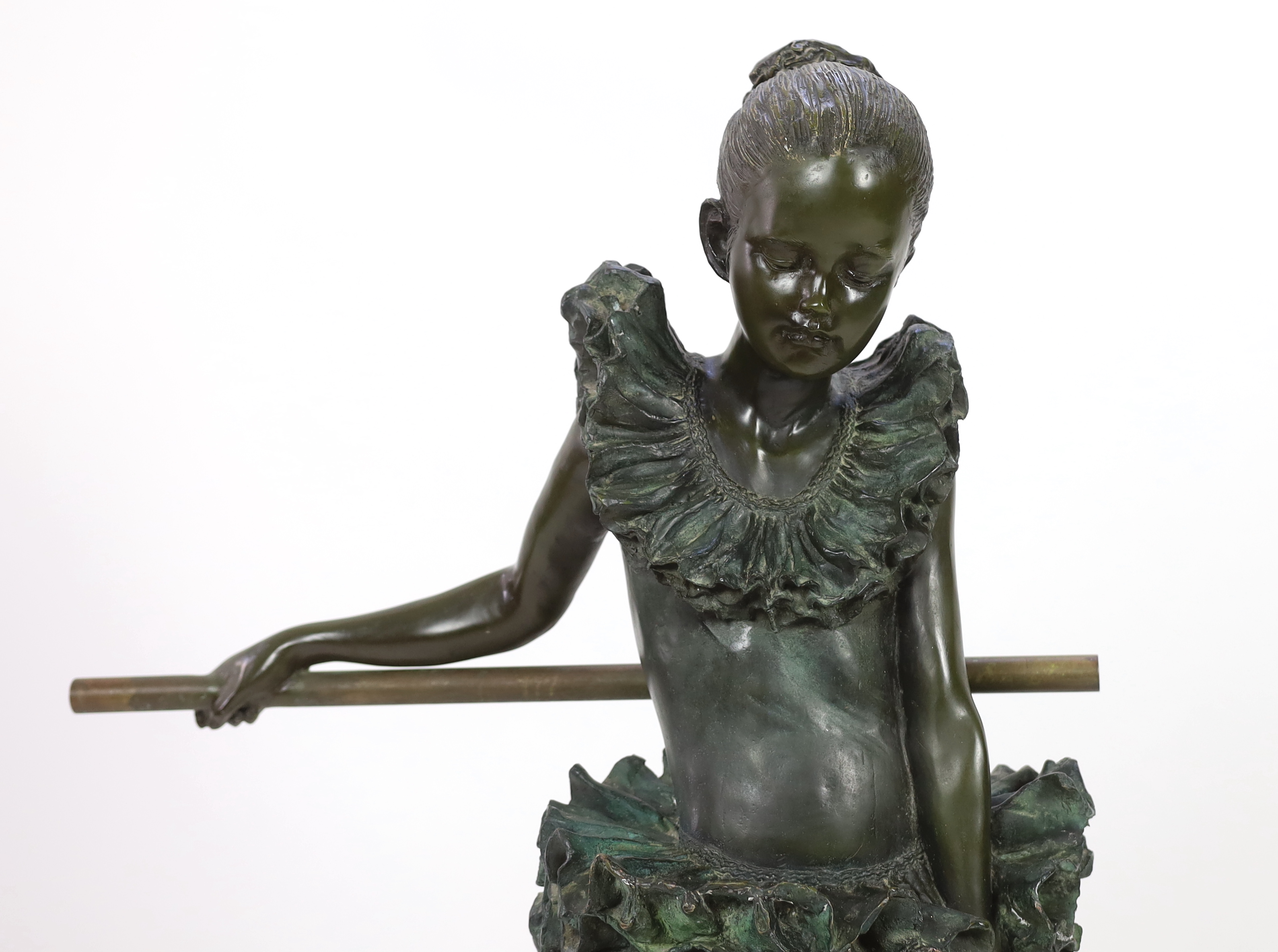 After Auguste Moreau (French, 1834-1917). A bronze figure of a ballerina, standing leaning against a rail, bears signature in the bronze, on marble plinth, height 110cm diameter 47cm.